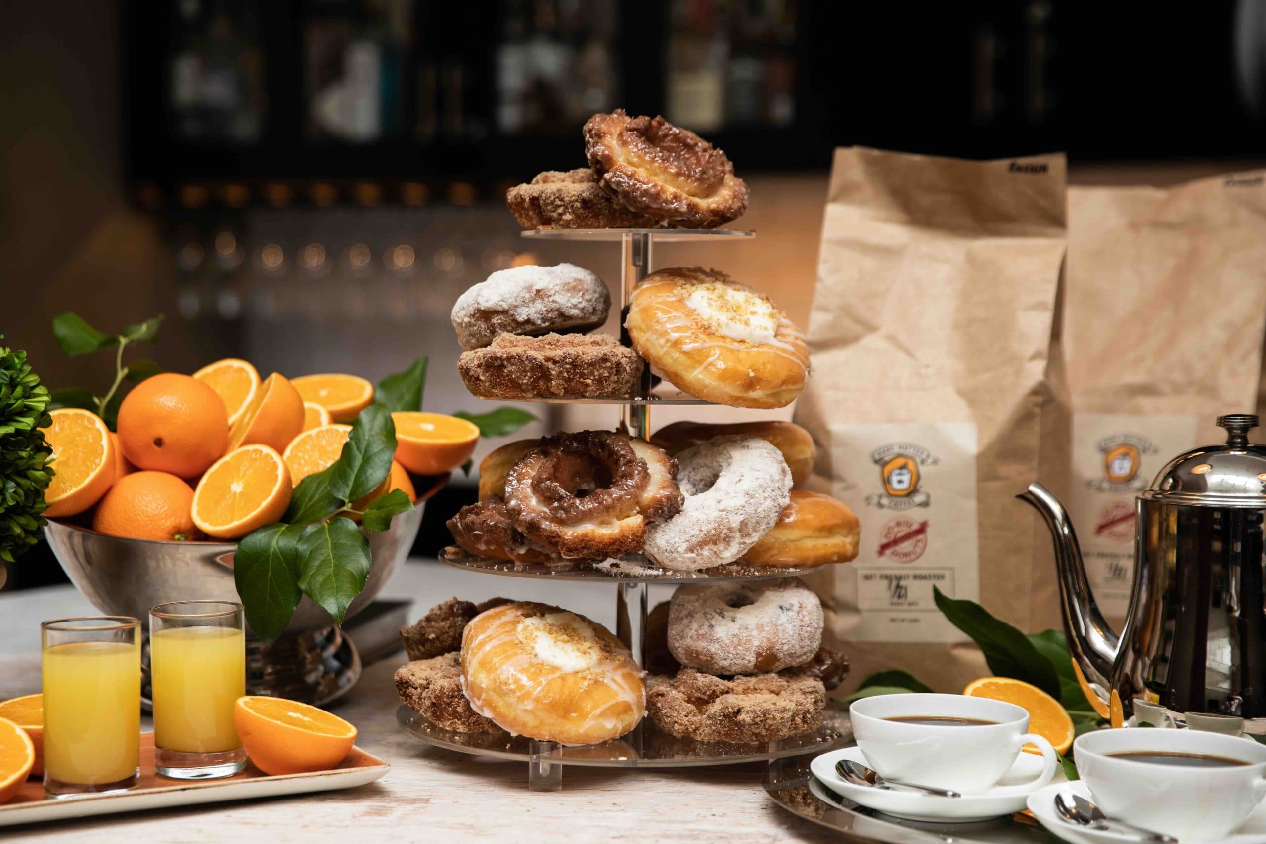 A brunch display of assorted donuts arranged on a tiered serving platter.